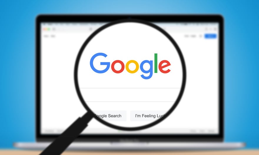 Google April SERP volatility Magnifying glass hovering over a laptop screen showing the Google search homepage