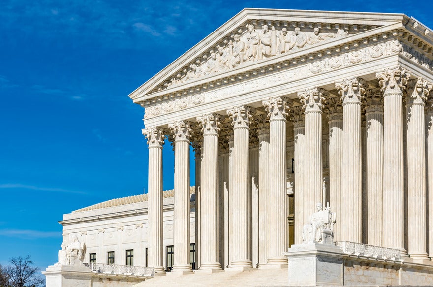 Supreme Court building with a blue sky backdrop