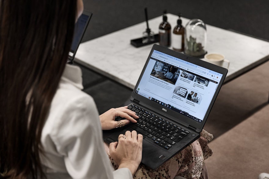 Web builder 2025 research announcement Woman working on a laptop