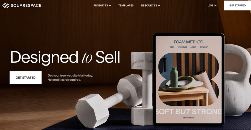 Squarespace Image of a Squarespace homepage mockup featuring a tablet with an open book and a water bottle on a table. Text overlay promotes website building tools and a free trial.